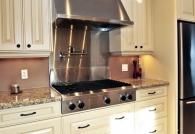 At what distance should the hood be placed above the hob?